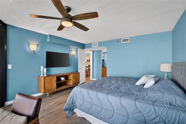 a bedroom with a bed and a flat screen tv