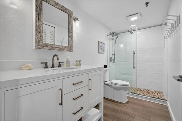 a bathroom with a toilet sink and a mirror