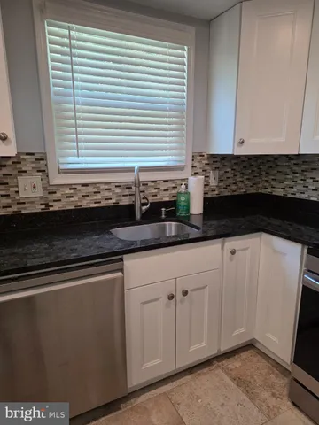 a view of empty room with wooden floor and fireplace