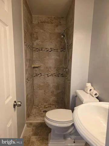 a bath room with a toilet and a bath tub