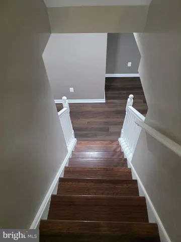 an empty room with wooden floor and closet