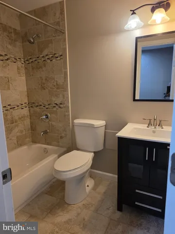 a bath room with a toilet and a bath tub