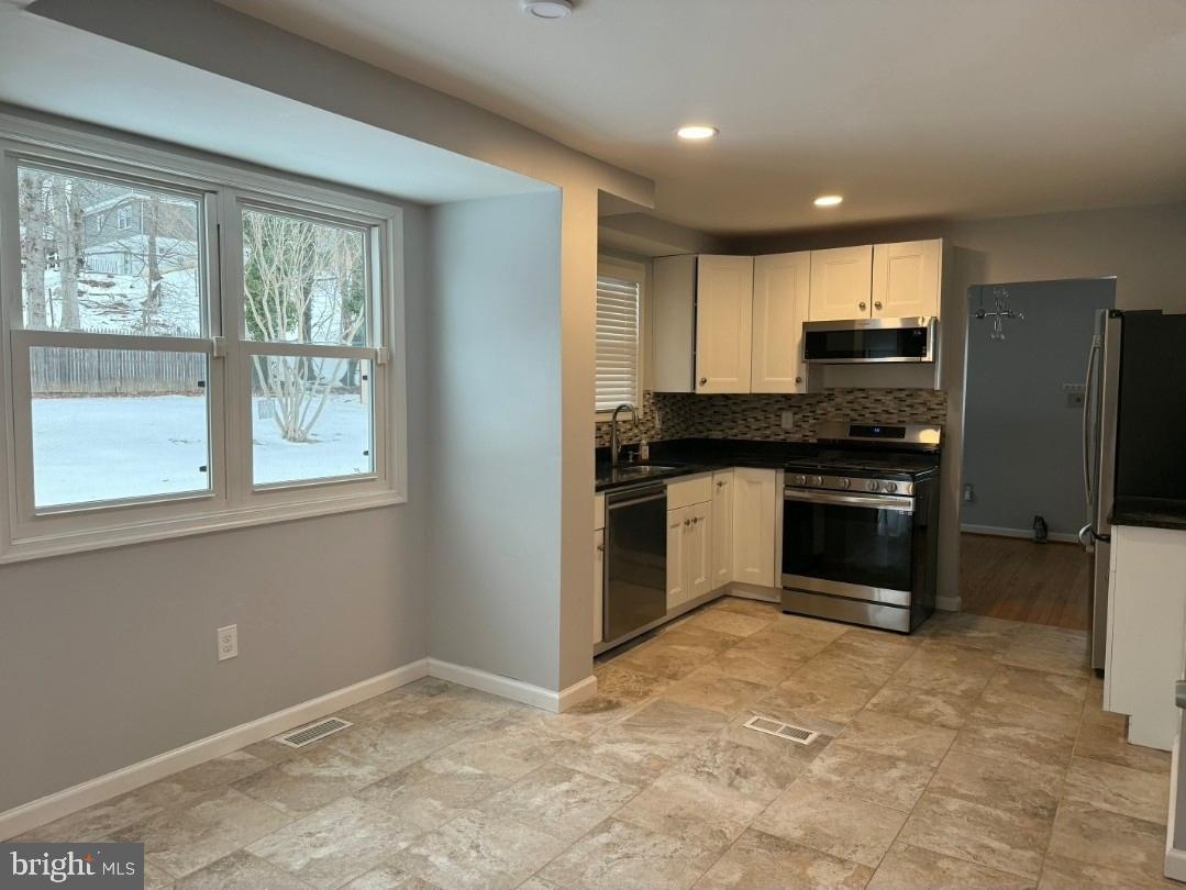 3002 Ivy Bridge Road Fort Washington, MD 20744 - Photo 37 of 71 a kitchen with stainless steel appliances granite countertop a stove a sink and a refrigerator