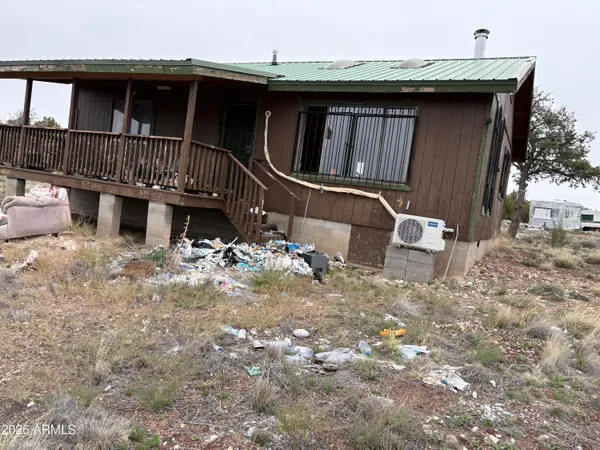 a view of a house with a wooden fence