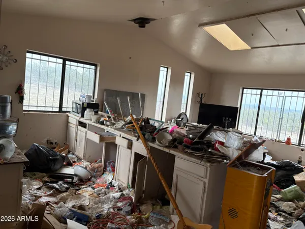 a room with furniture a flat screen tv and a window