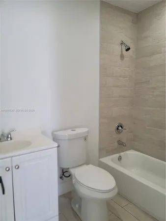 a white toilet sitting next to a bath tub