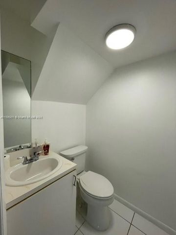 a bathroom with a sink mirror and toilet