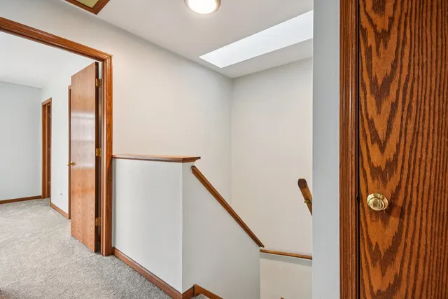a view of a kitchen with a sink and dishwasher with wooden floor