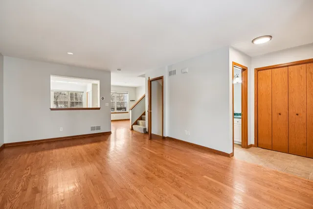 a kitchen with stainless steel appliances granite countertop a stove a sink dishwasher a refrigerator and a microwave oven with wooden floor