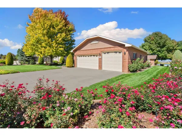 a view of a house with a big yard and potted plants