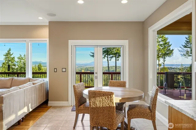 a dining room with furniture and a large window