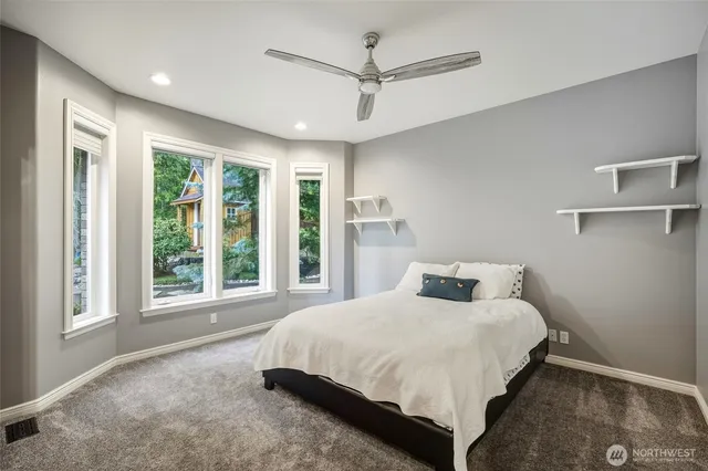 a bedroom with a large bed and a large window