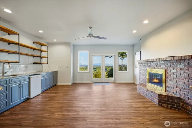 a large kitchen with stainless steel appliances granite countertop a stove and cabinets