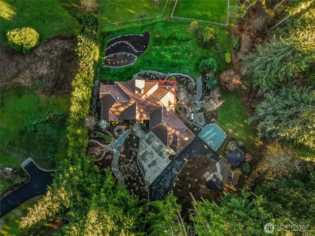 an aerial view of a house with a yard and lake view
