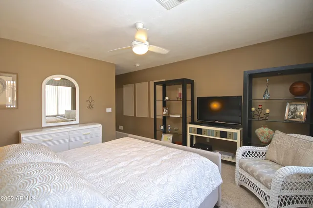 a bedroom with a bed and a chandelier