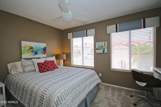 a bedroom with a bed and a window