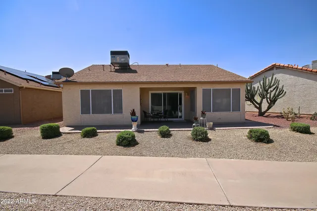 a view of a house with backyard sitting area and porch