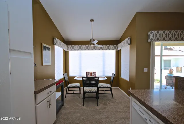 a dining room with furniture and window