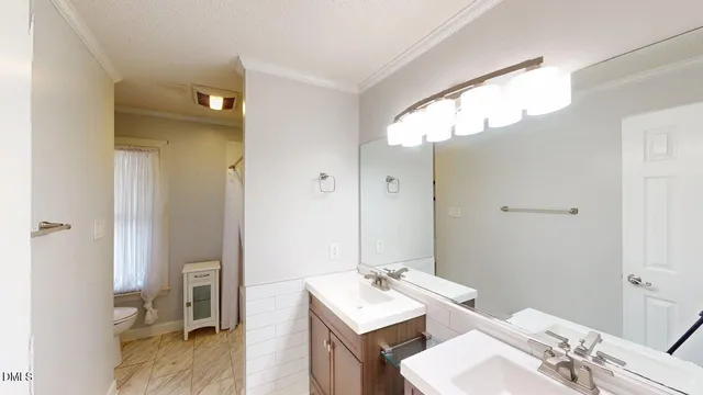 a bathroom with a sink vanity granite and a mirror