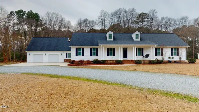 a swimming pool view with a seating space and a garden view