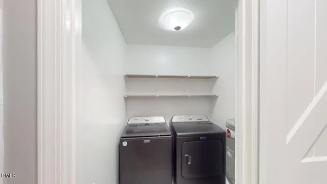 a view of a kitchen with granite countertop a sink and a refrigerator