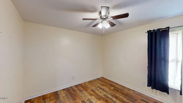 a view of a kitchen with refrigerator and windows