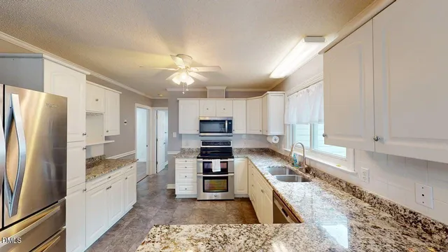 a bathroom with a sink vanity granite and toilet