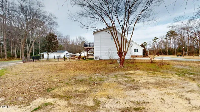 a view of a house with a backyard and garage