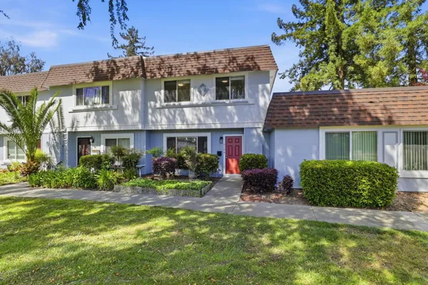 a front view of a house with yard and outdoor seating