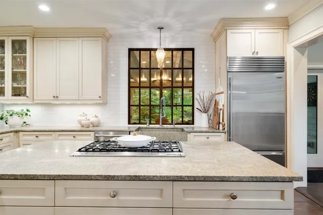 a living room with furniture a large window and a flat screen tv