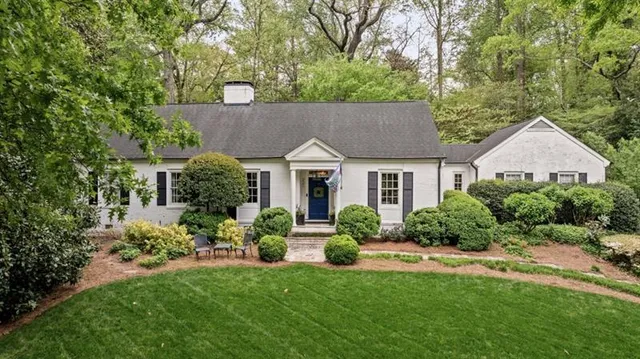 an empty room with wooden floor mirror and windows