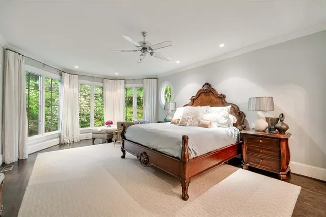 a white bath tub sitting in a bathroom next to a window