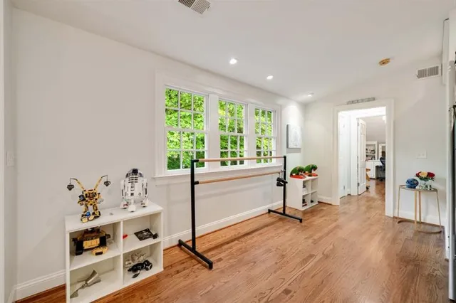 an aerial view of a house with a yard and large trees