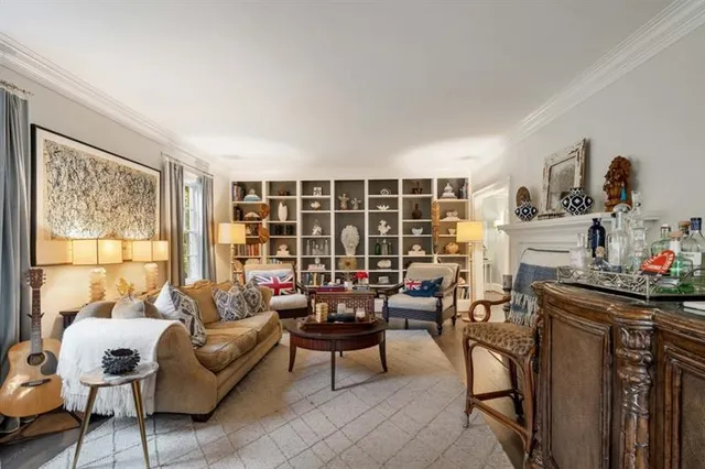 a kitchen with stainless steel appliances kitchen island granite countertop a dining table chairs and white cabinets