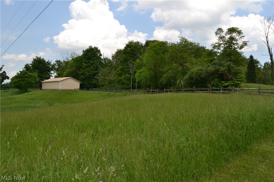 742 Highland Ridge Road Lowell, OH 45744 - Photo 31 of 31 View from across the road wihthteh driveway running to the right of the shed.