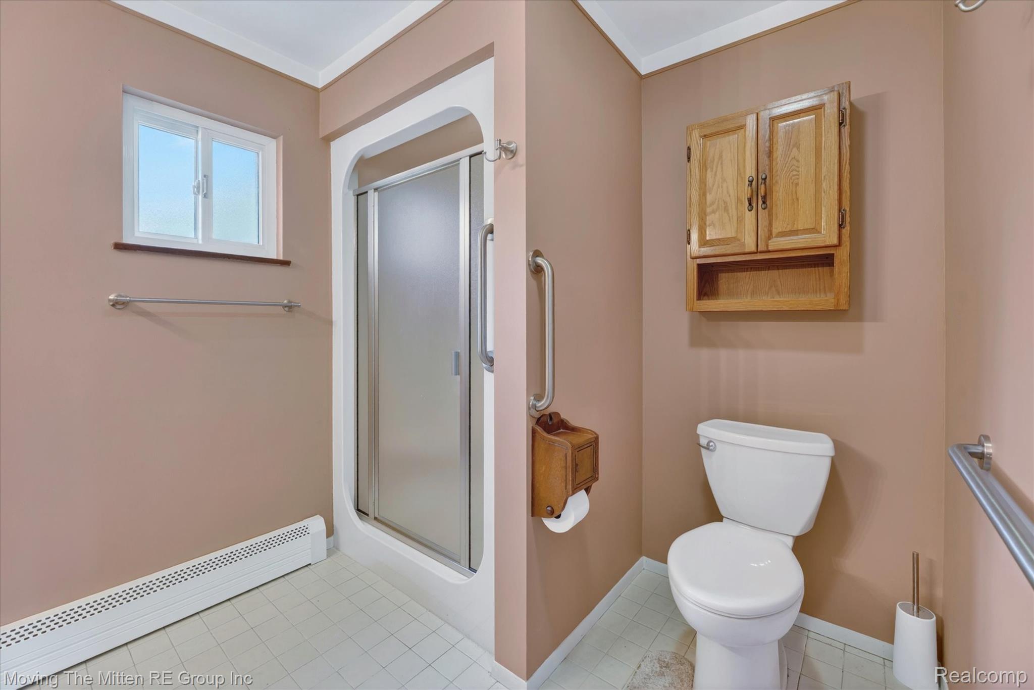 25505 Wick Road Taylor, MI 48180 - Photo 16 of 68 Full bathroom featuring a baseboard heating unit and a stall shower