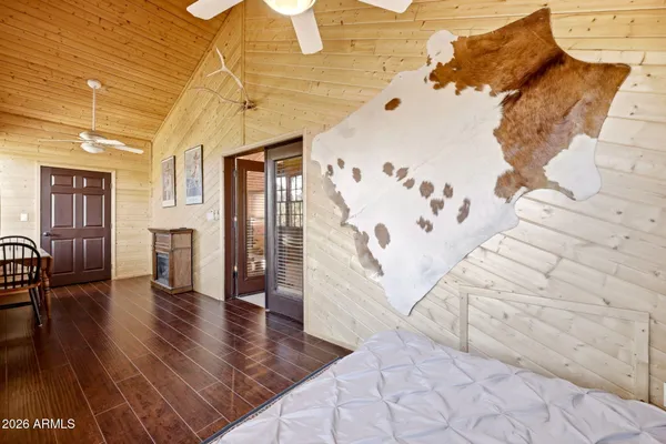 a spacious bedroom with a bed and a chandelier