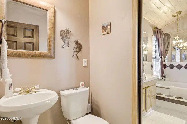 a bathroom with a white tub shower and sink