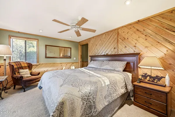 a bedroom with a bed and a painting on the wall