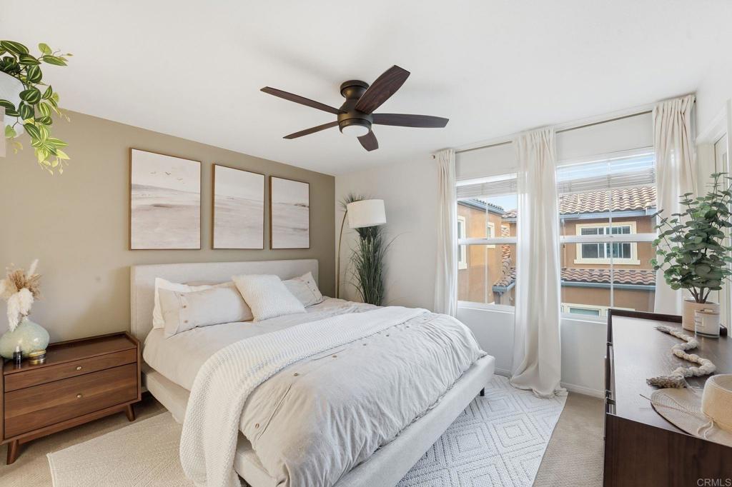 60 Via Sovana Santee, CA 92071 - Photo 12 of 26 a bedroom with a large bed and a chandelier fan