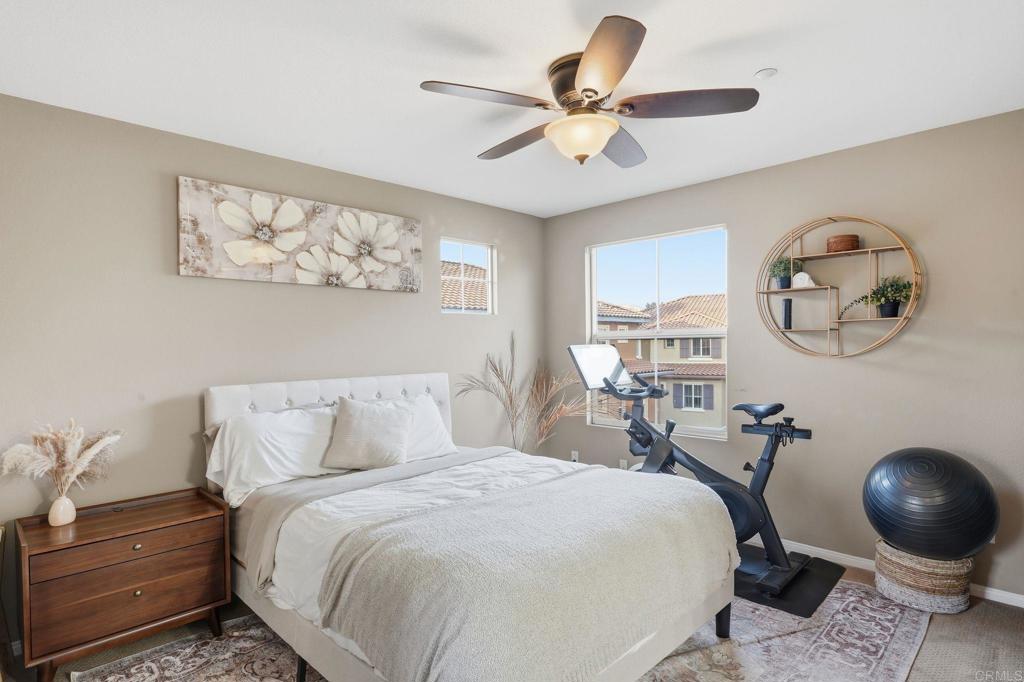 60 Via Sovana Santee, CA 92071 - Photo 16 of 26 a bedroom with a large bed and a chandelier