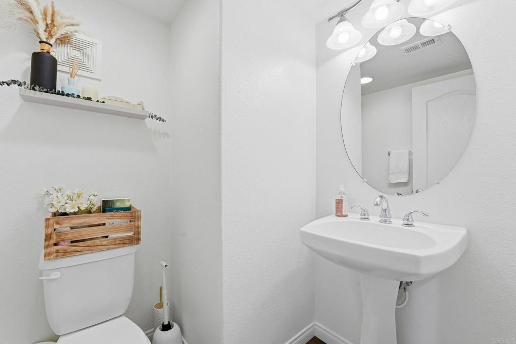 60 Via Sovana Santee, CA 92071 - Photo 19 of 26 a bathroom with a sink a toilet and mirror