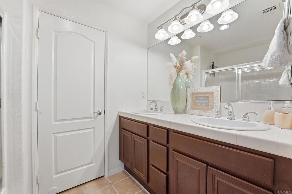 60 Via Sovana Santee, CA 92071 - Photo 20 of 26 a bathroom with a double vanity sink and a mirror