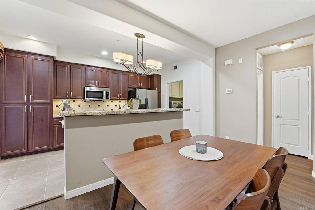 60 Via Sovana Santee, CA 92071 - Photo 7 of 26 a kitchen with kitchen island a dining table and chairs