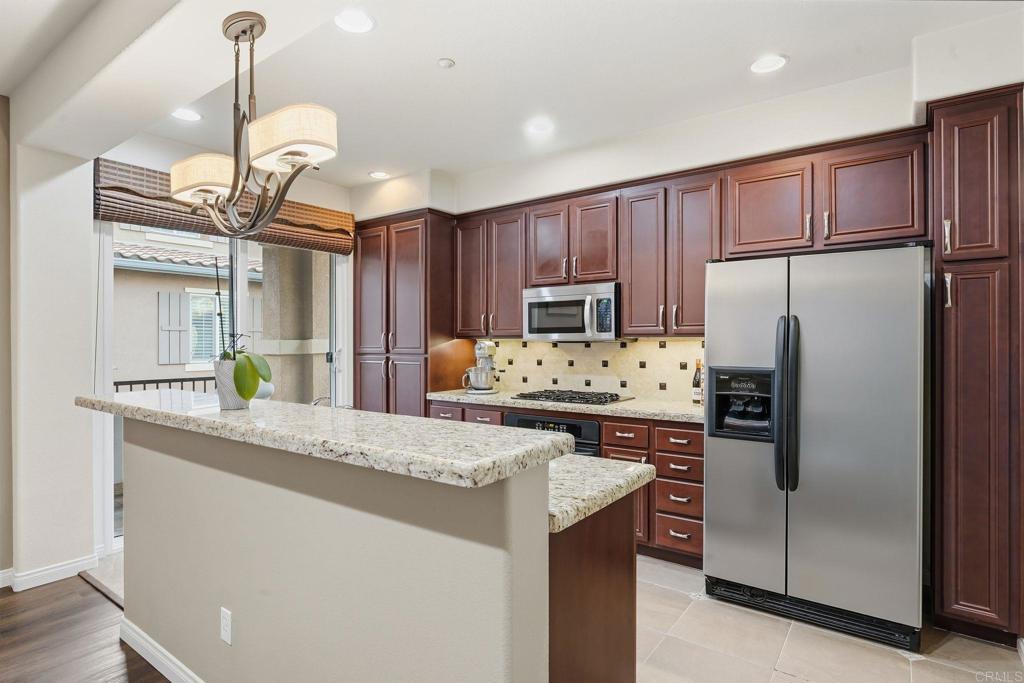 60 Via Sovana Santee, CA 92071 - Photo 8 of 26 a kitchen with refrigerator cabinets and a sink