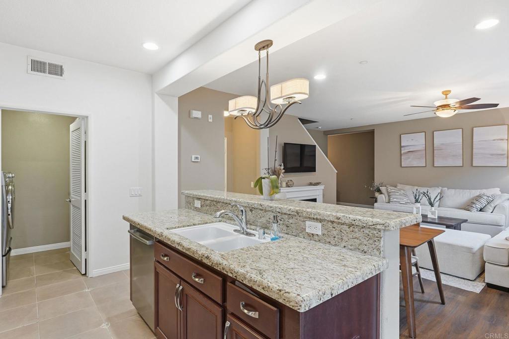 60 Via Sovana Santee, CA 92071 - Photo 10 of 26 a bathroom with a granite countertop sink and a mirror