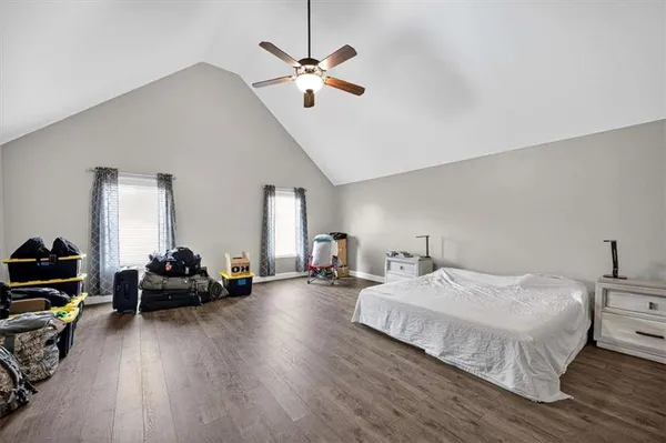 a bedroom with bed and a chandelier