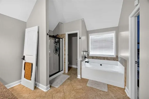 a bathroom with a tub and shower