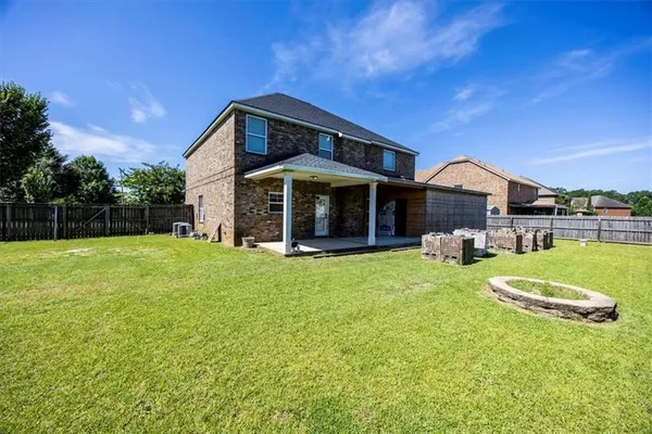 a view of a house with a swimming pool and a yard