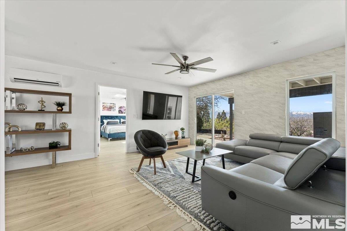 2665 Westview Boulevard Sparks, NV 89434 - Photo 13 of 33 a living room with furniture and a flat screen tv with kitchen view